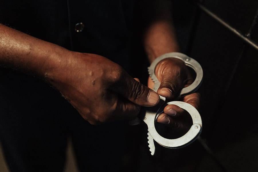 close-up-of-hands-holding-handcuffs-auburn-al